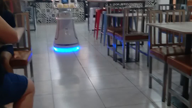 A Robot Waitress Delivers The Food